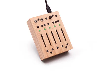 5 Moons recorder in a wooden case with five faders, buttons and a USB-C cable plugged in