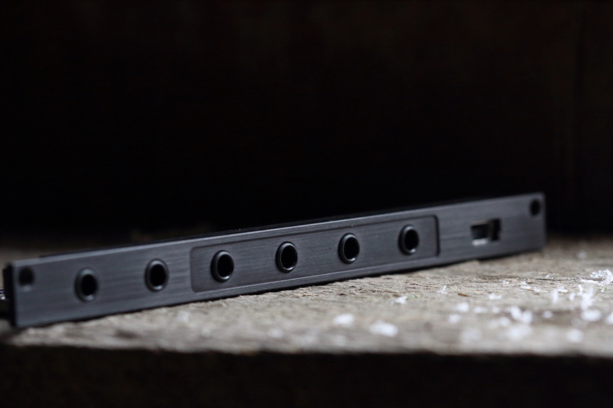 monome crow Eurorack module, a narrow black panel with four jacks, seen at an angle